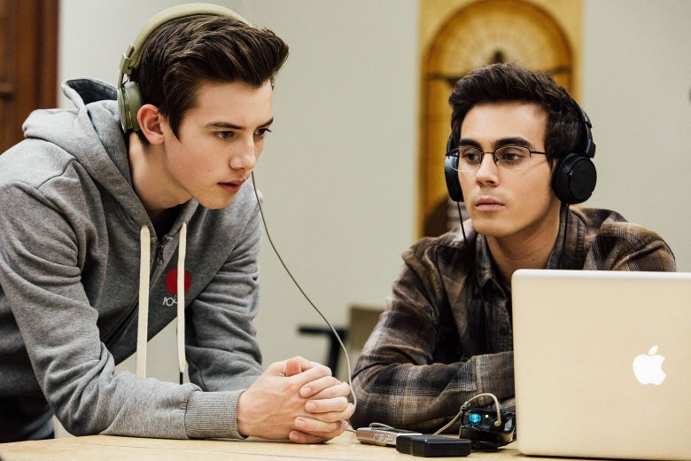 In a scene from American Vandal Season 2, Sam and Peter listen to a recording through their headphones.